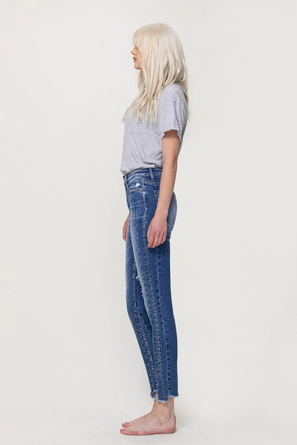 HIGH RISE ANKLE SKINNY W UNEVEN HEM DETAIL